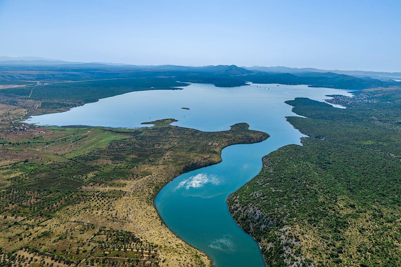 Aerial panoramic view of river and coastline landscape in Croatia with mountains and untouched nature