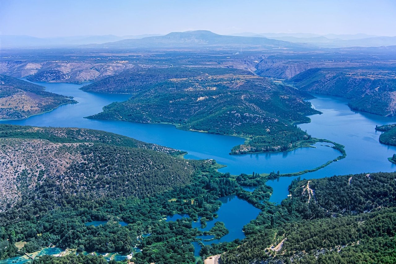 Aerial panoramic view of winding river and lush green landscape in Croatia