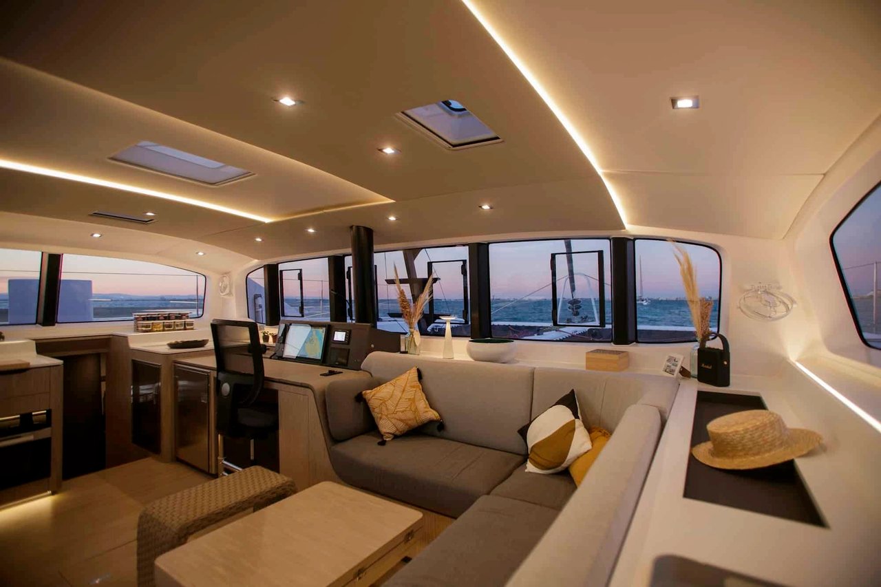 Elegant interior of a luxury sailing catamaran featuring a spacious lounge and navigation area with panoramic sea views in the Adriatic.