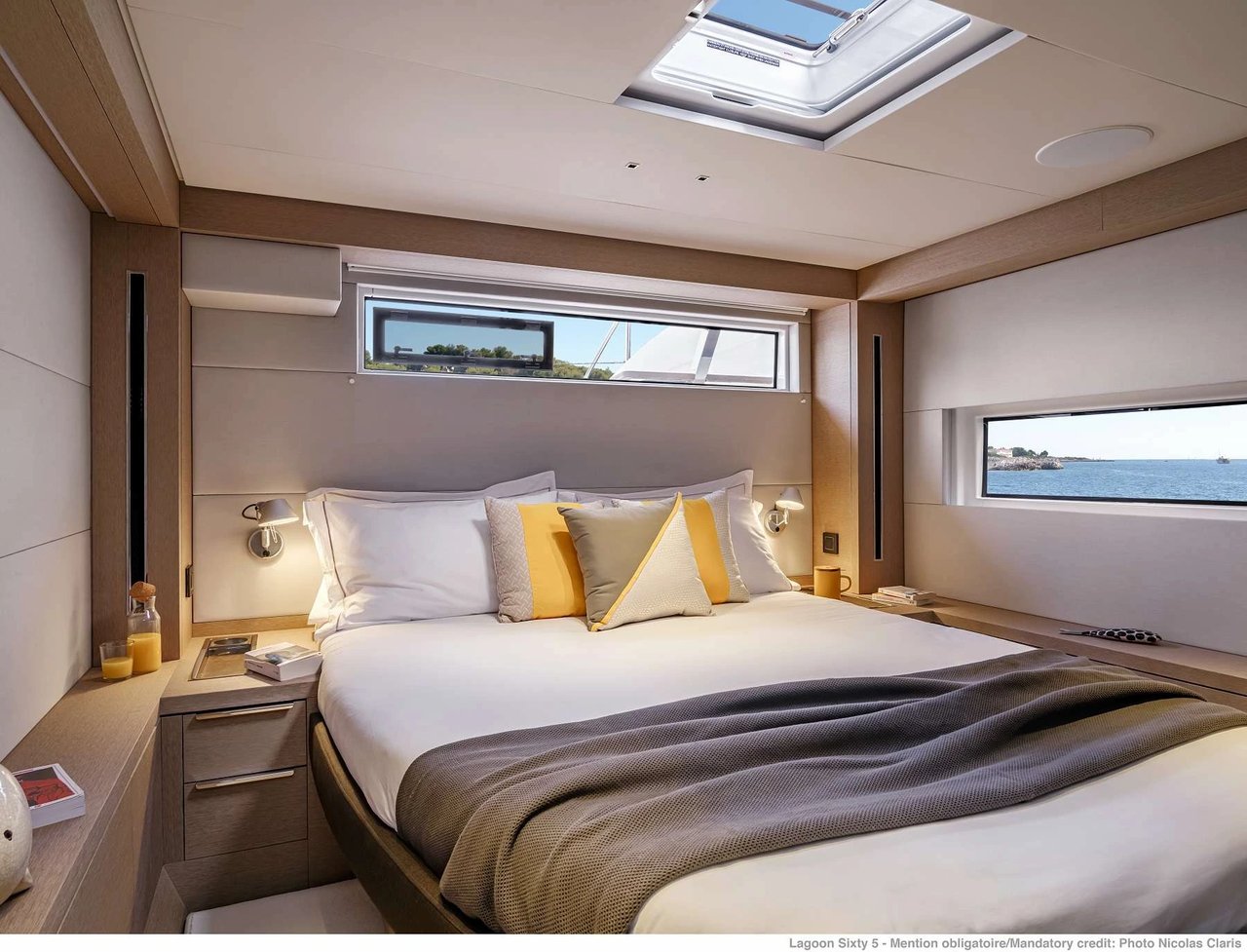 Elegant double cabin bedroom inside a luxury sailing catamaran with skylight and sea view windows in the Adriatic.