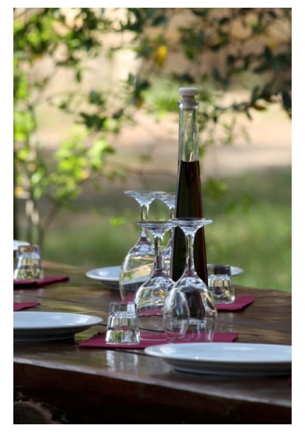Table set with wine glasses and local liqueur on a seaside tasting setup in Ston Bay, Croatia